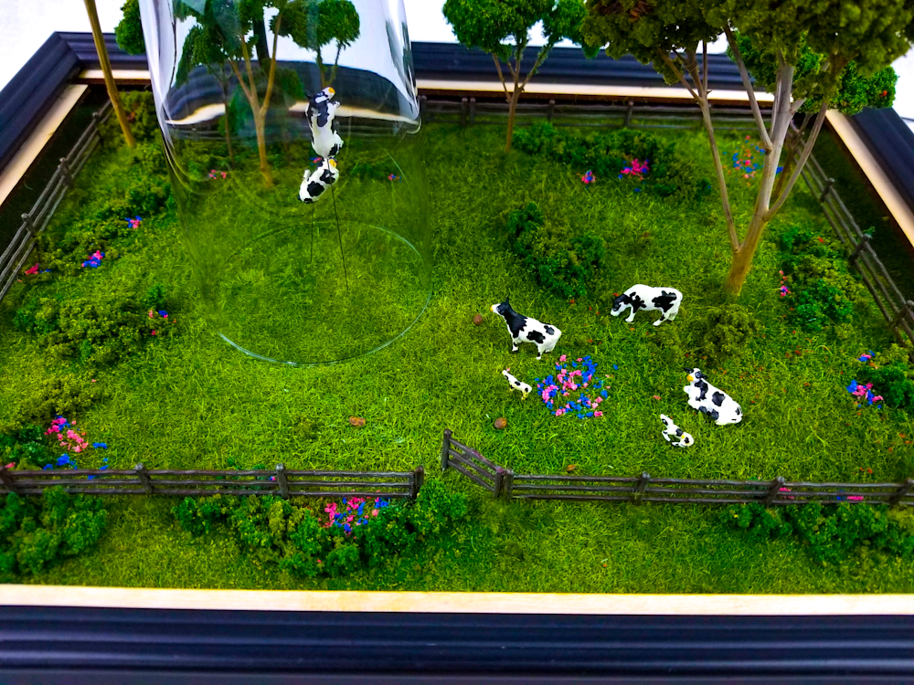 Alien Invasion sculpture by Jake Ashley featuring levitating cows and UFO